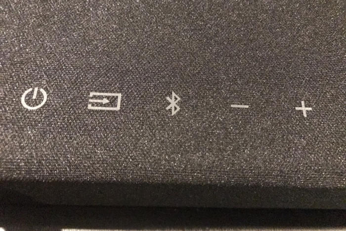 The top of the sound bar has basic, functional buttons.